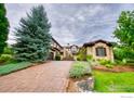Luxury home with brick driveway and landscaping at 6851 Goldbranch Dr, Niwot, CO 80503
