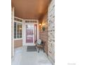 Front entry with a bench and red door at 859 Topaz St, Superior, CO 80027