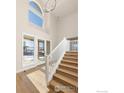 Bright entryway with hardwood floors and staircase at 944 Saint Andrews Ln, Louisville, CO 80027