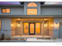 Front entrance with stone accents and a covered porch at 944 Saint Andrews Ln, Louisville, CO 80027