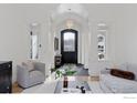 Bright and airy living room with high ceilings and a neutral color palette at 1312 Jade Ln, Longmont, CO 80504