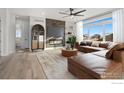Living room with L-shaped sectional sofa and fireplace at 1369 Burt Ave, Berthoud, CO 80513