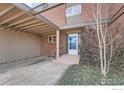 Townhouse entryway with brick facade and blue door at 1518 Chambers Dr, Boulder, CO 80305