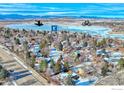 Aerial view of residential neighborhood near lake with mountain backdrop at 1701 Harvard St, Longmont, CO 80503