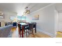 Elegant dining area with hardwood floors and a modern light fixture at 1777 Larimer St # 1608, Denver, CO 80202