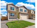 Two-story house with beige siding, gray shutters, and a two-car garage at 2236 Crosswind St, Fort Lupton, CO 80621