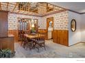 Dining room with wood paneling, mirrored ceiling, and wood table at 2250 Grape Ave, Boulder, CO 80304