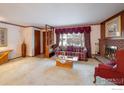 Living room with fireplace, wood paneling, and window view at 2250 Grape Ave, Boulder, CO 80304