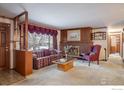 Living room with fireplace, and wood paneled walls at 2250 Grape Ave, Boulder, CO 80304