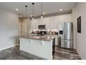 Modern kitchen with stainless steel appliances and an island at 2324 W 164Th Pl, Broomfield, CO 80023