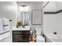 Clean bathroom with dark vanity, white subway tile and a bathtub at 2428 Yukon Dr, Longmont, CO 80504