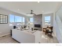 Bright living room with a stone fireplace, large windows, and comfortable seating at 2715 Crystal Springs, Longmont, CO 80503