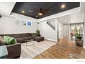 Spacious living room featuring hardwood floors and a modern sectional sofa at 306 Se 4Th St, Berthoud, CO 80513