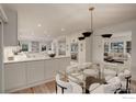 Modern kitchen boasts white cabinets, stainless steel appliances, and an island at 330 16Th St, Boulder, CO 80302