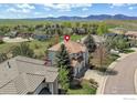 House with red tile roof and mountain views in background at 380 Edison Pl, Superior, CO 80027