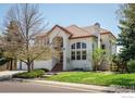 Two-story home with stucco exterior, red tile roof and landscaping at 380 Edison Pl, Superior, CO 80027