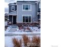 Gray townhome with stone accents and landscaping; snowy winter scene at 5108 Buckwheat Rd, Brighton, CO 80640