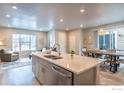 Spacious kitchen with light gray cabinets, quartz countertops, and stainless steel appliances at 5108 Buckwheat Rd, Brighton, CO 80640