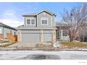 Two-story house with gray siding, double garage, and landscaping at 628 Saint Andrews Dr, Longmont, CO 80504