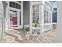 Inviting front porch with small table and chairs, perfect for relaxing at 628 Saint Andrews Dr, Longmont, CO 80504