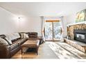 Living room with L-shaped sectional sofa and stone fireplace at 6545 Kalua Rd # 203D, Boulder, CO 80301