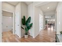 Bright entryway with hardwood floors, leading to bathroom and living area at 747 Cristo Ln, Lafayette, CO 80026