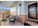 Relaxing front porch with seating area, stone accents, and view of the street at 747 Cristo Ln, Lafayette, CO 80026