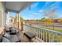 Covered porch with wicker furniture and view of the neighborhood at 747 Cristo Ln, Lafayette, CO 80026