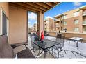 Snow-covered patio with metal table and chairs, offering a cozy outdoor space at 1053 W Century Dr # 102, Louisville, CO 80027