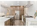 Gourmet kitchen with stainless steel appliances and custom cabinetry at 1702 Montgomery Cir, Longmont, CO 80504