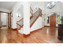 Elegant staircase with wrought iron railing and hardwood floors at 2121 Jade Way, Longmont, CO 80504