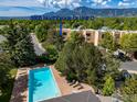 Community pool with lounge chairs and mountain backdrop at 3805 Northbrook Dr # D, Boulder, CO 80304