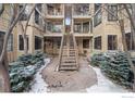Exterior view of multi-level condo buildings, showcasing landscaping and walkway to second story condos at 4862 E Kentucky Ave # D, Denver, CO 80246