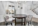 Round table with gray chairs in a bright dining area at 4964 Shenandoah Ave, Firestone, CO 80504