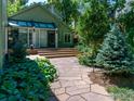 Landscaped backyard with stone pathway, lush greenery, and serene atmosphere at 531 Arapahoe Ave, Boulder, CO 80302