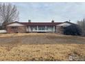 Brick ranch home with a long covered porch at 6397 Ute Hwy, Longmont, CO 80503