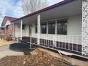 Covered porch with ornate railing and entryway at 6397 Ute Hwy, Longmont, CO 80503
