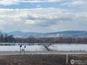 Scenic view of a lake with mountains in the background at 6397 Ute Hwy, Longmont, CO 80503