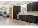 Open concept kitchen with dark cabinetry and stainless steel appliances at 755 Cristo Ln # C, Lafayette, CO 80026