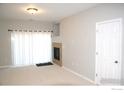Living room with fireplace, sliding glass doors, and neutral walls at 804 Summer Hawk Dr # 9106, Longmont, CO 80504