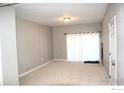 Spacious living room with sliding glass doors and neutral decor at 804 Summer Hawk Dr # 9106, Longmont, CO 80504
