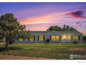 House exterior at sunset, showcasing the home's curb appeal at 8260 County Road 39, Fort Lupton, CO 80621