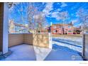 Tan colored patio with view of neighboring townhouses at 8428 Everett Way # B, Arvada, CO 80005