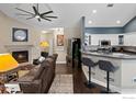 Open floor plan with kitchen, living room and fireplace at 9692 W Coco Cir # 201, Littleton, CO 80128