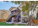 Backyard oasis with hot tub, deck, and artificial grass at 1155 Mcmurdo Cir, Castle Rock, CO 80108