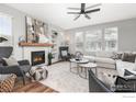 Spacious living room featuring a modern fireplace, comfortable seating, and large windows at 11830 Raleigh Pl, Westminster, CO 80031