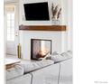 Modern fireplace with a sleek design and a large TV above it at 1221 W 144Th Ct, Westminster, CO 80023