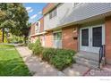 Townhouse exterior with walkway, landscaping, and double doors at 12974 W Virginia Ave, Lakewood, CO 80228