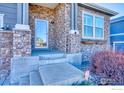 Inviting front entrance with stone accents and a covered porch at 13460 Trenton St, Thornton, CO 80602