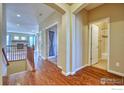 Bright hallway with hardwood floors and access to bedrooms and a bathroom at 13460 Trenton St, Thornton, CO 80602